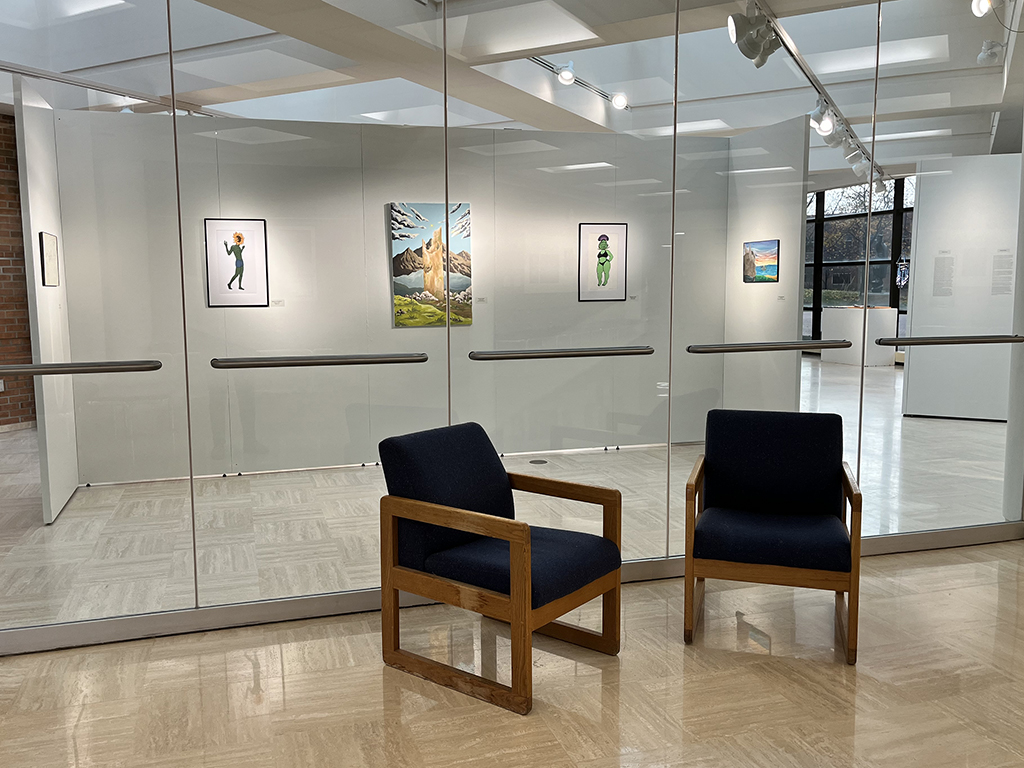 Front wall of exhibition with work by Arnold and Walker behind glass looking in from the lobby